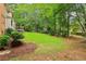Expansive backyard with a well-kept lawn, mature trees and privacy, ideal for outdoor activities and entertaining at 828 Guinevere Sw Way, Lilburn, GA 30047