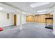 Spacious finished basement featuring gray carpet and wood paneling, ideal for versatile use at 828 Guinevere Sw Way, Lilburn, GA 30047
