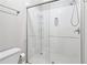 Clean bathroom featuring a glass-enclosed shower with modern fixtures and a convenient storage caddy at 828 Guinevere Sw Way, Lilburn, GA 30047