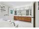 Large bathroom features a garden tub, tile floors, double sinks with vanities and large mirrors at 828 Guinevere Sw Way, Lilburn, GA 30047