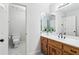 Well-lit bathroom with vanity, sink, and toilet at 828 Guinevere Sw Way, Lilburn, GA 30047