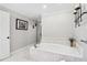 Large bathroom features a soaking tub, tiled floors, and white walls at 828 Guinevere Sw Way, Lilburn, GA 30047