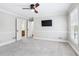 Bedroom with carpet, light walls, and two double doors with bathroom and closet access at 828 Guinevere Sw Way, Lilburn, GA 30047