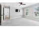 Spacious bedroom features neutral decor, carpeted floors, and a ceiling fan at 828 Guinevere Sw Way, Lilburn, GA 30047
