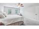 Spacious bedroom features plush carpet, two windows and a luxurious cushioned headboard at 828 Guinevere Sw Way, Lilburn, GA 30047