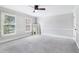 Large bedroom with carpet, natural light, and a neutral color scheme creating a serene atmosphere at 828 Guinevere Sw Way, Lilburn, GA 30047