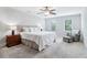Bright bedroom boasts plush carpet, neutral walls, and a luxurious, cushioned headboard at 828 Guinevere Sw Way, Lilburn, GA 30047