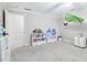 Bright bedroom with carpeted floors and ample room for activities at 828 Guinevere Sw Way, Lilburn, GA 30047