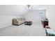 Bright bonus room with a neutral color palette, plush carpet, and a cozy sofa at 828 Guinevere Sw Way, Lilburn, GA 30047