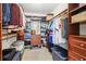 Walk-in closet with custom shelves, hanging racks, wooden drawers and storage organizers at 828 Guinevere Sw Way, Lilburn, GA 30047