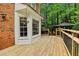 Wooden deck with black metal railing, white trim, and view of gazebo and backyard at 828 Guinevere Sw Way, Lilburn, GA 30047