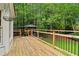 Wooden deck overlooking a lush backyard with mature trees and a gazebo at 828 Guinevere Sw Way, Lilburn, GA 30047