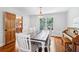 Bright dining room with hardwood floors, farmhouse table, and views of backyard at 828 Guinevere Sw Way, Lilburn, GA 30047