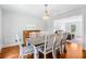 Elegant dining room features a farmhouse table, piano, and modern chandelier at 828 Guinevere Sw Way, Lilburn, GA 30047