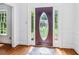 Entryway featuring a decorative front door, sidelights and wood floors at 828 Guinevere Sw Way, Lilburn, GA 30047