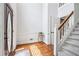 Bright foyer featuring hardwood floors, staircase, and a decorative front door at 828 Guinevere Sw Way, Lilburn, GA 30047