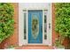 Close up of front door with decorative glass, sidelights, and potted flowers at 828 Guinevere Sw Way, Lilburn, GA 30047