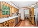 Kitchen with wood cabinets, stainless appliances, and a view into the dining room at 828 Guinevere Sw Way, Lilburn, GA 30047