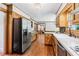 Well-lit kitchen with stainless steel appliances, white countertops, and wood cabinets at 828 Guinevere Sw Way, Lilburn, GA 30047