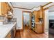 Kitchen featuring stainless steel appliances and natural wood cabinets at 828 Guinevere Sw Way, Lilburn, GA 30047
