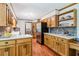 Bright kitchen with oak cabinets, stainless steel appliances, and stone backsplash at 828 Guinevere Sw Way, Lilburn, GA 30047
