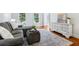 Comfortable living room with hardwood floors, neutral furniture, and bright natural light at 828 Guinevere Sw Way, Lilburn, GA 30047