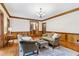Charming living room with beautiful hardwood floors, wainscoting, and warm lighting at 828 Guinevere Sw Way, Lilburn, GA 30047