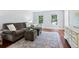 Comfortable living room with hardwood floors, neutral furniture, and bright natural light at 828 Guinevere Sw Way, Lilburn, GA 30047