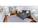 Cozy living room featuring hardwood floors, neutral furniture, and an adjacent dining area at 828 Guinevere Sw Way, Lilburn, GA 30047