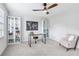 Bright home office with a large window, decorative bookshelves, and a modern desk at 828 Guinevere Sw Way, Lilburn, GA 30047