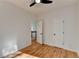 A bedroom boasts hardwood flooring, a ceiling fan, and a white door at 1285 Cedar Brook Dr, Lawrenceville, GA 30043