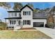 Charming two-story home with white brick, black shutters, and a well-manicured front lawn at 1285 Cedar Brook Dr, Lawrenceville, GA 30043