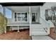 Inviting front porch with white railings and stairs, leading to the main entrance of the house at 1285 Cedar Brook Dr, Lawrenceville, GA 30043