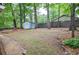 A spacious backyard offering a peaceful retreat, complete with a charming storage shed amidst lush greenery at 1438 Ridgeland Sw Ct, Lilburn, GA 30047