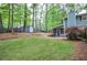 This large backyard features mature trees, a shed, and a screened-in porch at 1438 Ridgeland Sw Ct, Lilburn, GA 30047