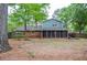 Large backyard features a screened in porch, mature trees, and lots of room to roam at 1438 Ridgeland Sw Ct, Lilburn, GA 30047
