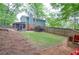 Expansive backyard with lush greenery, playhouse, and screened porch, perfect for entertaining or enjoying the outdoors at 1438 Ridgeland Sw Ct, Lilburn, GA 30047