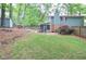 A spacious, green backyard features a screened-in porch and a cute storage shed, adding to the home's outdoor appeal at 1438 Ridgeland Sw Ct, Lilburn, GA 30047
