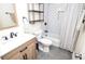 This bright bathroom features subway tile shower, hex tile floors, wood vanity, and modern fixtures at 1438 Ridgeland Sw Ct, Lilburn, GA 30047