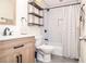Bright bathroom features subway tile shower, hex tile floors, wood vanity, and modern black hardware and fixtures at 1438 Ridgeland Sw Ct, Lilburn, GA 30047