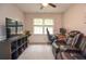 Well-lit bedroom featuring a desk, a plush two-seat recliner, and a neutral color scheme at 1438 Ridgeland Sw Ct, Lilburn, GA 30047