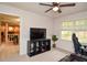 Bedroom with a desk, entertainment center, and comfortable seating, offering a flexible living space at 1438 Ridgeland Sw Ct, Lilburn, GA 30047