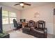 Cozy bedroom with a desk, plush seating, and a ceiling fan, offering a comfortable retreat at 1438 Ridgeland Sw Ct, Lilburn, GA 30047