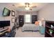 Cozy bedroom features a ceiling fan, lots of light, and room for a desk and bookcases at 1438 Ridgeland Sw Ct, Lilburn, GA 30047