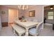 Traditional dining room featuring a chandelier, a neutral color palette and a table with bench seating at 1438 Ridgeland Sw Ct, Lilburn, GA 30047