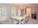 Elegant dining room featuring a chandelier, large windows, and ample space for hosting gatherings at 1438 Ridgeland Sw Ct, Lilburn, GA 30047