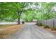 Long driveway leading to the home, surrounded by mature trees and landscaping, creating a private and serene setting at 1438 Ridgeland Sw Ct, Lilburn, GA 30047