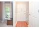 Bright entryway with natural light from windows, wood floors, storage bench, and access to the stairs at 1438 Ridgeland Sw Ct, Lilburn, GA 30047