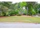 Charming home with a lush green lawn and mature trees providing shade and curb appeal at 1438 Ridgeland Sw Ct, Lilburn, GA 30047