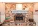 Stone fireplace with a white mantel and decorative items, providing a cozy and inviting focal point in the room at 1438 Ridgeland Sw Ct, Lilburn, GA 30047
